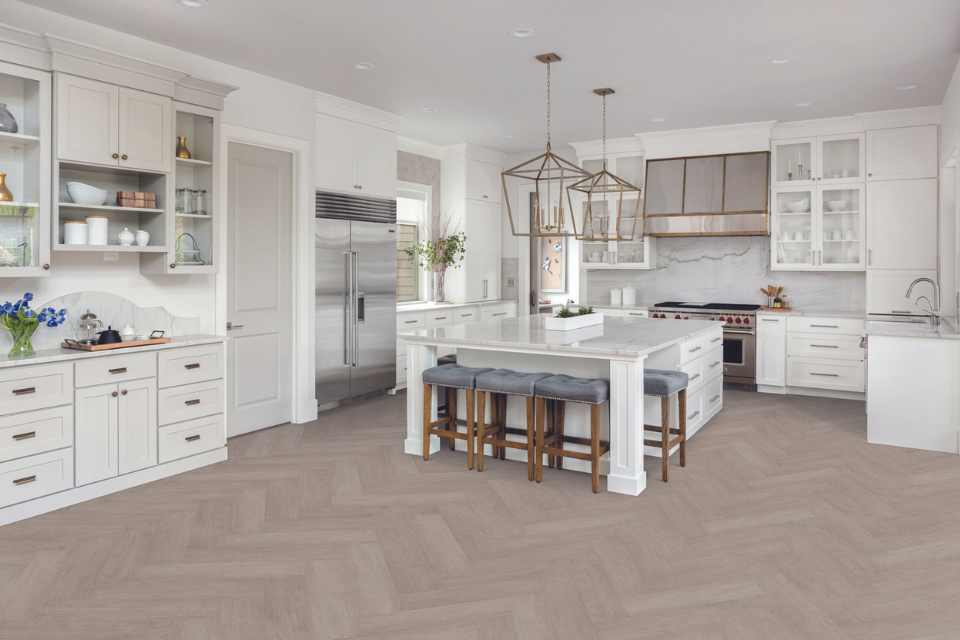 gray herringbone luxury vinyl in all white modern kitchen